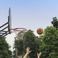 Hands of player throwing basketball ball into basket. Street basketball game. Basketball shield, Basket and ball on Royalty Free Stock Photo