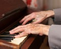 Hands playing a harmonium