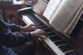 Hands playing piano while reading music sheets Royalty Free Stock Photo