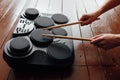 Hands playing on portable electronic drums