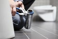 Hands plumber at work in a bathroom, plumbing repair service, as Royalty Free Stock Photo