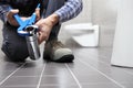 Hands plumber at work in a bathroom, plumbing repair service, as