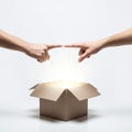 Hands Pointing to a Sparkling Open Box Royalty Free Stock Photo