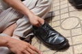 Hands polish leather black shoes