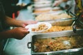 The hands of the poor handed a plate to receive food from volunteers to alleviate hunger, the concept of helping the homeless Royalty Free Stock Photo