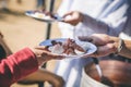 The hands of the poor handed a plate to receive food from volunteers to alleviate hunger, the concept of helping the homeless Royalty Free Stock Photo