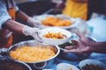 The hands of the poor have been begging to donate food from the donor, The concept of feeding Royalty Free Stock Photo