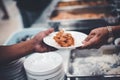 The hands of the poor have been begging to donate food from the donor : the concept of feeding Royalty Free Stock Photo