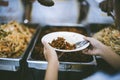 The hands of the poor have been begging to donate food from the donor, The concept of feeding Royalty Free Stock Photo