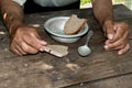 Hands the poor old man& x27;s, piece of bread and empty bowl on wood Royalty Free Stock Photo