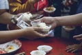 Hands of the poor receive food from the donor`s share. poverty concept Royalty Free Stock Photo