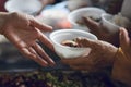 Hands of the poor receive food from the donor`s share. poverty concept Royalty Free Stock Photo