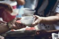 Hands of the poor receive food from the donor`s share. poverty concept Royalty Free Stock Photo