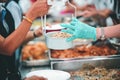 The hands of the poor receive food from the hands of the philanthropist : concept of giving