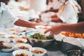 The hands of the poor receive food that volunteers share to alleviate hunger: the concept of donating food to the poor Royalty Free Stock Photo