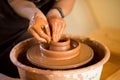 Hands of potte makes pottery dishes on potter`s wheel. Sculptor in workshop makes clay product Royalty Free Stock Photo