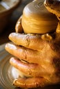 Hands of a potter, creating an earthen jar