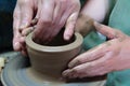 Hands of a potter, creating an earthen jar on pottery wheel. Royalty Free Stock Photo