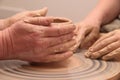 Hands of a potter, creating an earthen jar on pottery wheel. Royalty Free Stock Photo