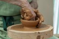 Hands of potter creating a jar