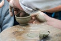 Hands of potter do a clay pot on the street at the fair Royalty Free Stock Photo