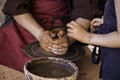 Hands of a potter forming clay