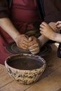 Hands of a potter forming clay