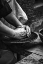 Hands of a potter shaping clay