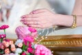 Hands pouring blessing water into bride`s bands, Thai wedding. Royalty Free Stock Photo