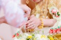 Hands pouring blessing water into bride`s bands, Thai wedding. Royalty Free Stock Photo