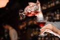 Hands pouring a fresh alcoholic drink into the cocktail glass Royalty Free Stock Photo