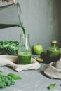 Hands pouring healthy green smoothie in a jar. Healthy eating concept