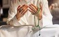 Hands, prayer beads and muslim man praying in mosque, temple or church. Islam, worship and islamic male with beads for Royalty Free Stock Photo