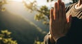 Prayer Hand Gesture Held Outdoors, Sunlight Filtering Through Trees, Natural Background-(AI Generated) Royalty Free Stock Photo