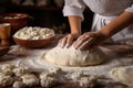 Hands-on preparation of Easter bread, with dough being skillfully kneaded amid a collection of traditional ingredients