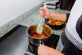 Hands preparing candy on an induction cooker