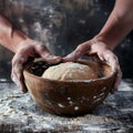 Hands preparing dough closeup, dough in a bowl on rustic kitchen table, hands making pizza, bread Royalty Free Stock Photo