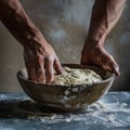 Hands preparing dough closeup, dough in a bowl on rustic kitchen table, hands making pizza, bread Royalty Free Stock Photo