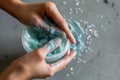 hands preparing a facial mask with visible microbeads content Royalty Free Stock Photo