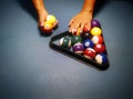 Hands preparing pool balls in triangle rack on the billiard table Royalty Free Stock Photo