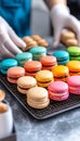 Hands Presenting Trays of Multicolored French Macarons on a Wire Cooling Rack., Bakery , Dessert