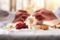 Hands of a priest consecrating a host on the altar