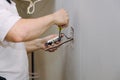 Hands professional during mounting of electrical outlets connector installed in plasterboard drywall for gypsum walls Royalty Free Stock Photo