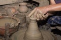 Hands of Professional Thai man using mechanic pottery made earthenware at `Koh Kret` in Thailand