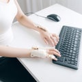 Hands of programmer with disability using prosthetic arm to work . Royalty Free Stock Photo