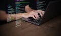 Hands of a programmer types on a laptop displaying programming code, symbolizing coding tech, software development, web Royalty Free Stock Photo