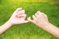 Hands promises together of Mom and her daughter