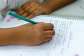 Hands of a public school student doing school work in a notebook. City of Salvador, Bahia Royalty Free Stock Photo