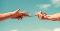 Hands pull hard on the rope, save against the sky. Rope, cord. Hand holding a rope, climbing rope, strength and determination Royalty Free Stock Photo