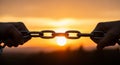 Hands Pulling Apart a Metal Chain Against a Sunset Sky link connection Royalty Free Stock Photo